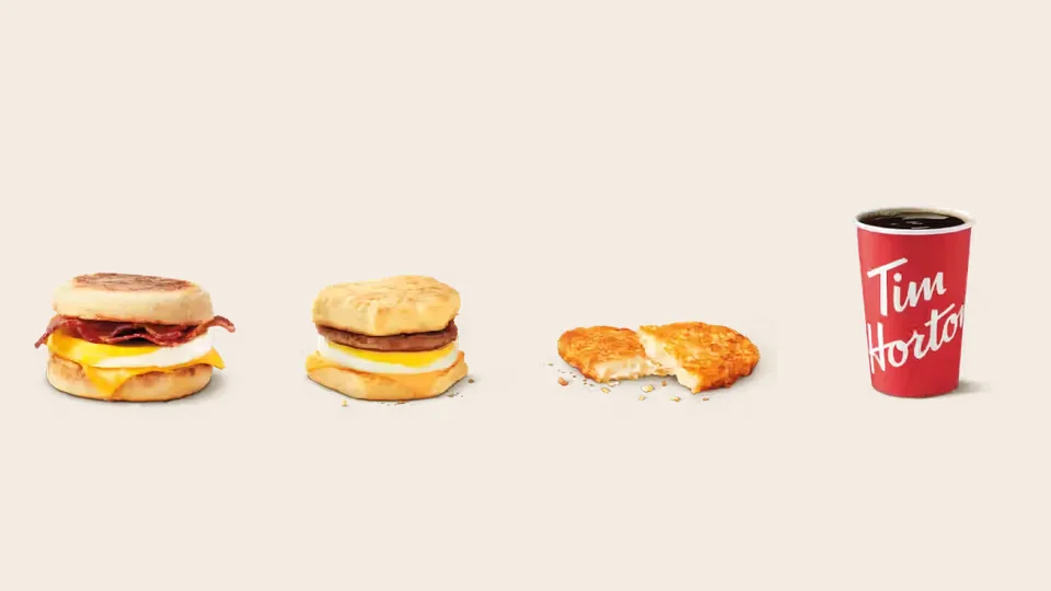 A Tim Hortons Bacon Breakfast Sandwich, Sausage Breakfast Sandwich, Hashbrown and brewed coffee